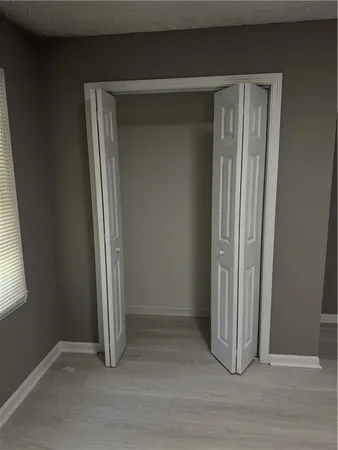 an empty room with wooden floor and a window