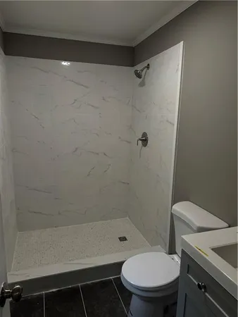 a bathroom with a toilet and a shower