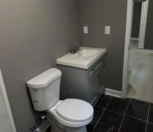 a white toilet sitting next to a bathroom sink