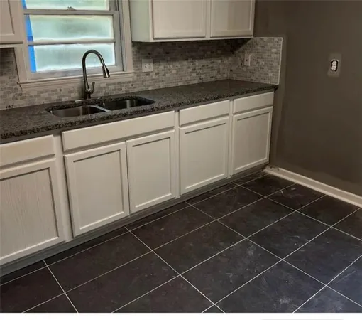 a kitchen with a sink and cabinets