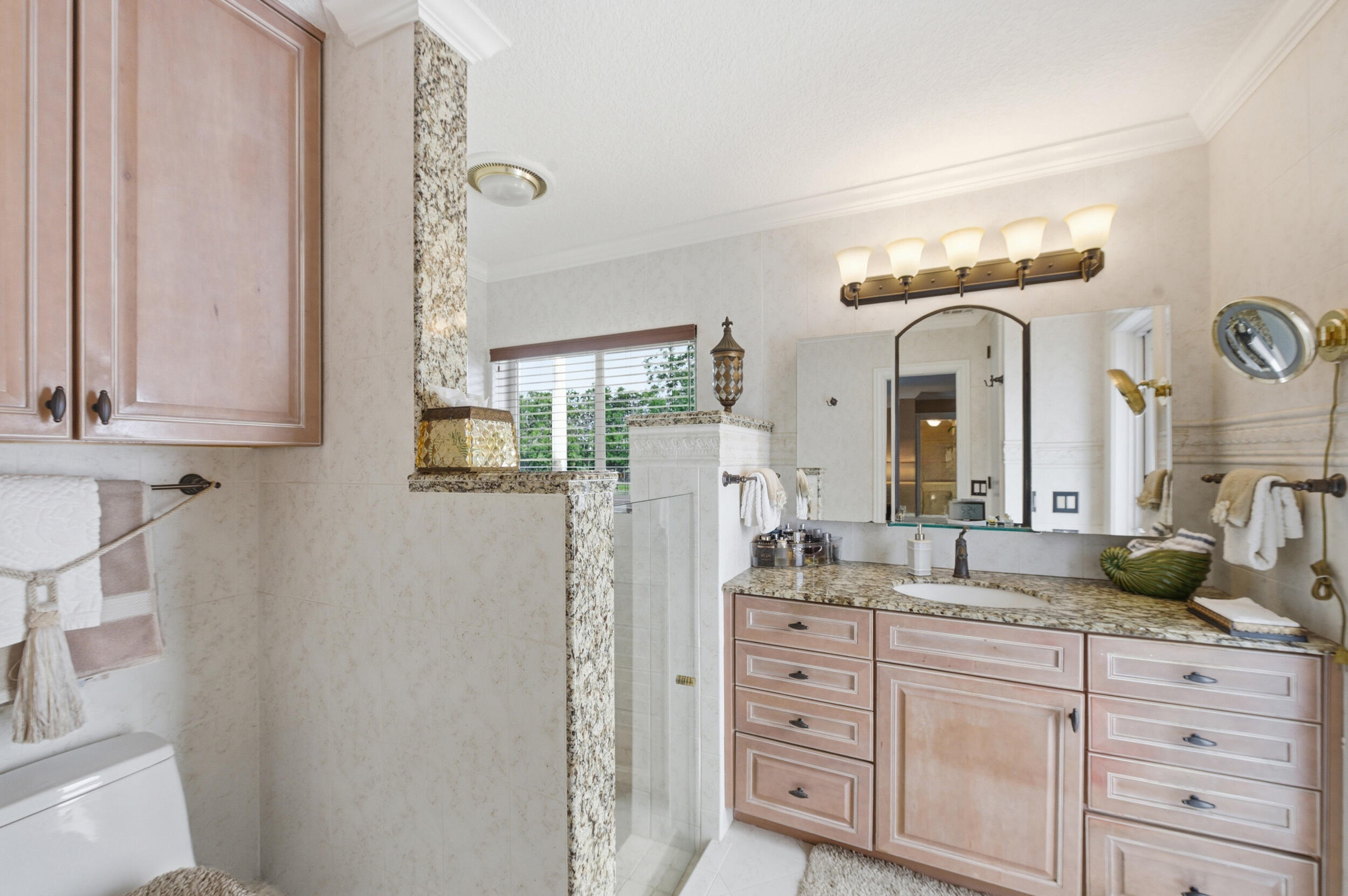 4780 Brandywine Drive Boca Raton, FL 33487 - Photo 22 of 43 a spacious bathroom with a granite countertop sink and a mirror