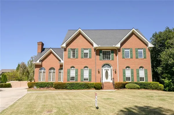 a front view of a house with a yard