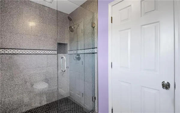 a bathroom with a granite countertop sink a toilet and shower