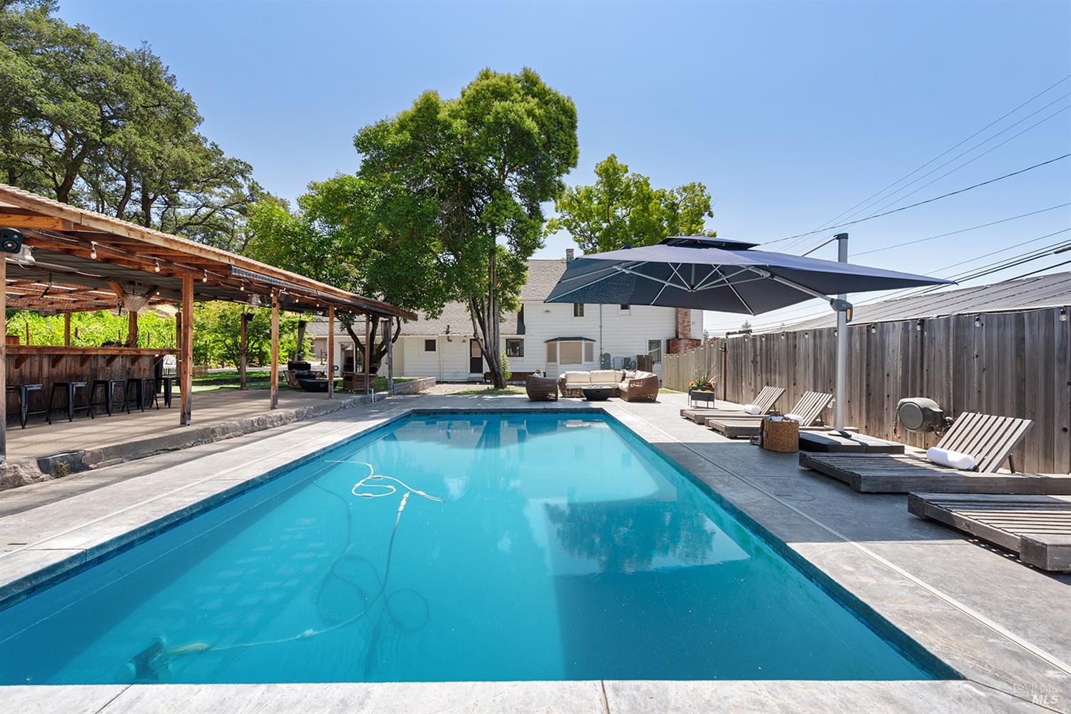 a view of a patio with swimming pool table and chairs