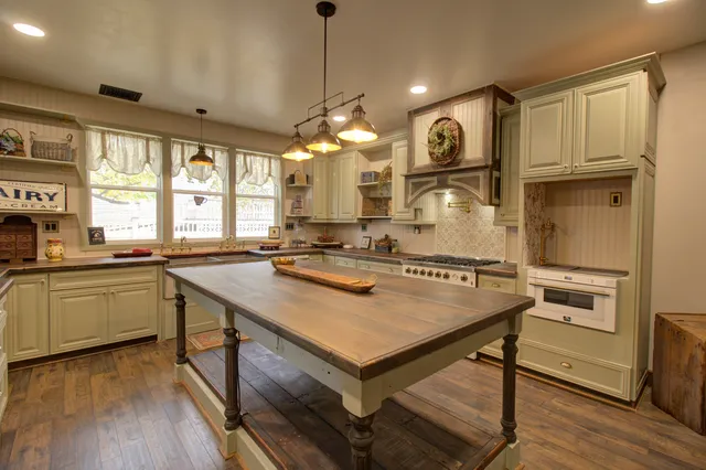 a kitchen with stainless steel appliances granite countertop a stove and a refrigerator