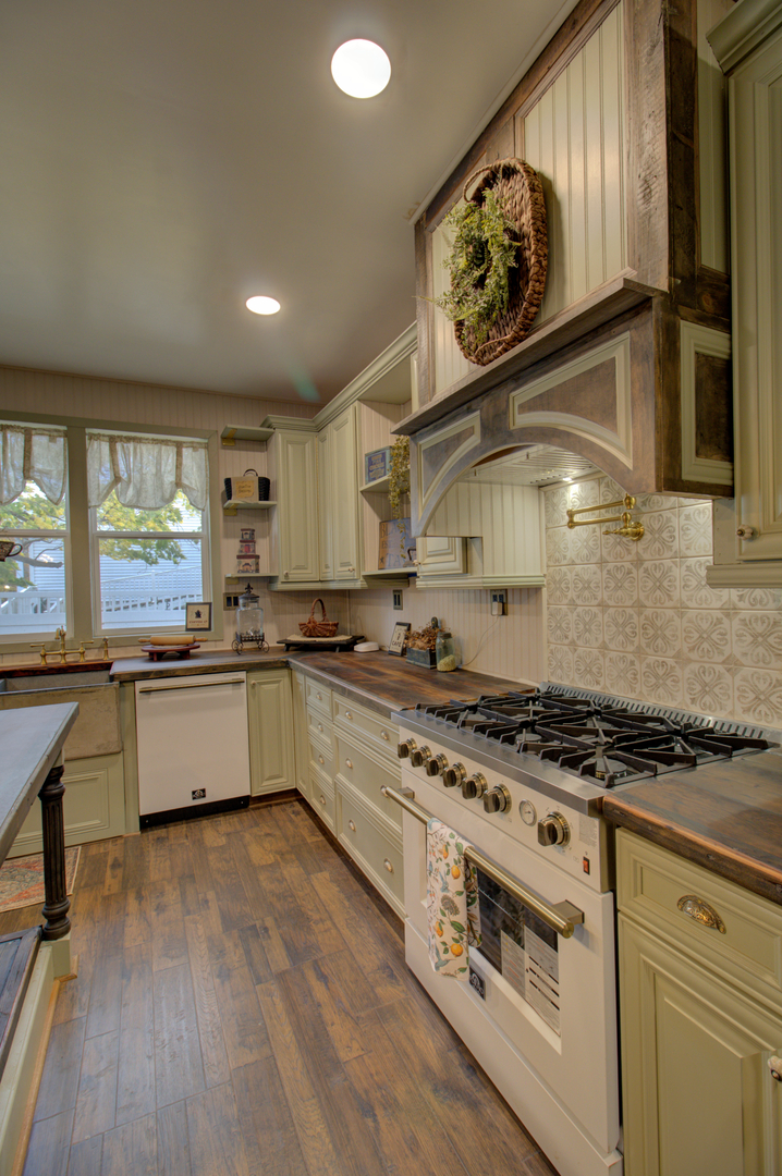 402 West Lincoln Way Morrison, IL 61270 - Photo 19 of 43 a large kitchen with stainless steel appliances granite countertop a stove and a large window