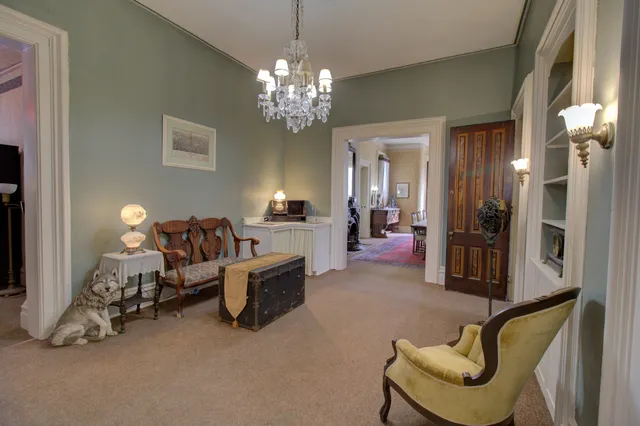 a living room with furniture and a chandelier