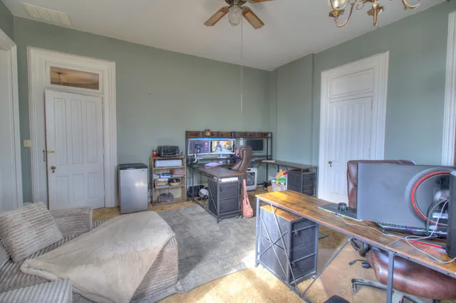 a bedroom with a bed window and a desk