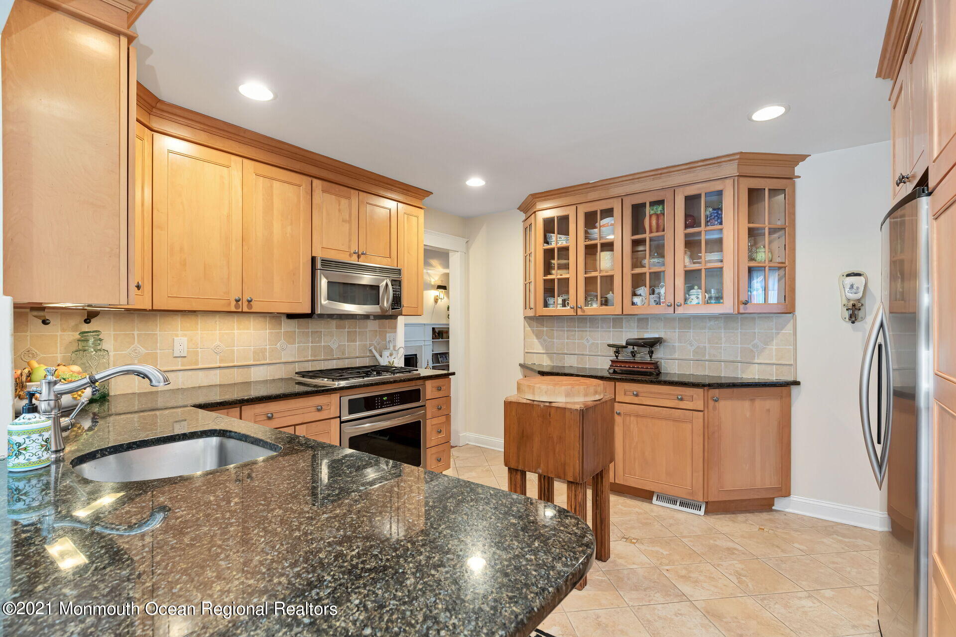 16 Westwood Road Little Silver, NJ 07739 - Photo 20 of 39 a kitchen with stainless steel appliances granite countertop a stove top oven a sink dishwasher a dining table and chairs with wooden floor