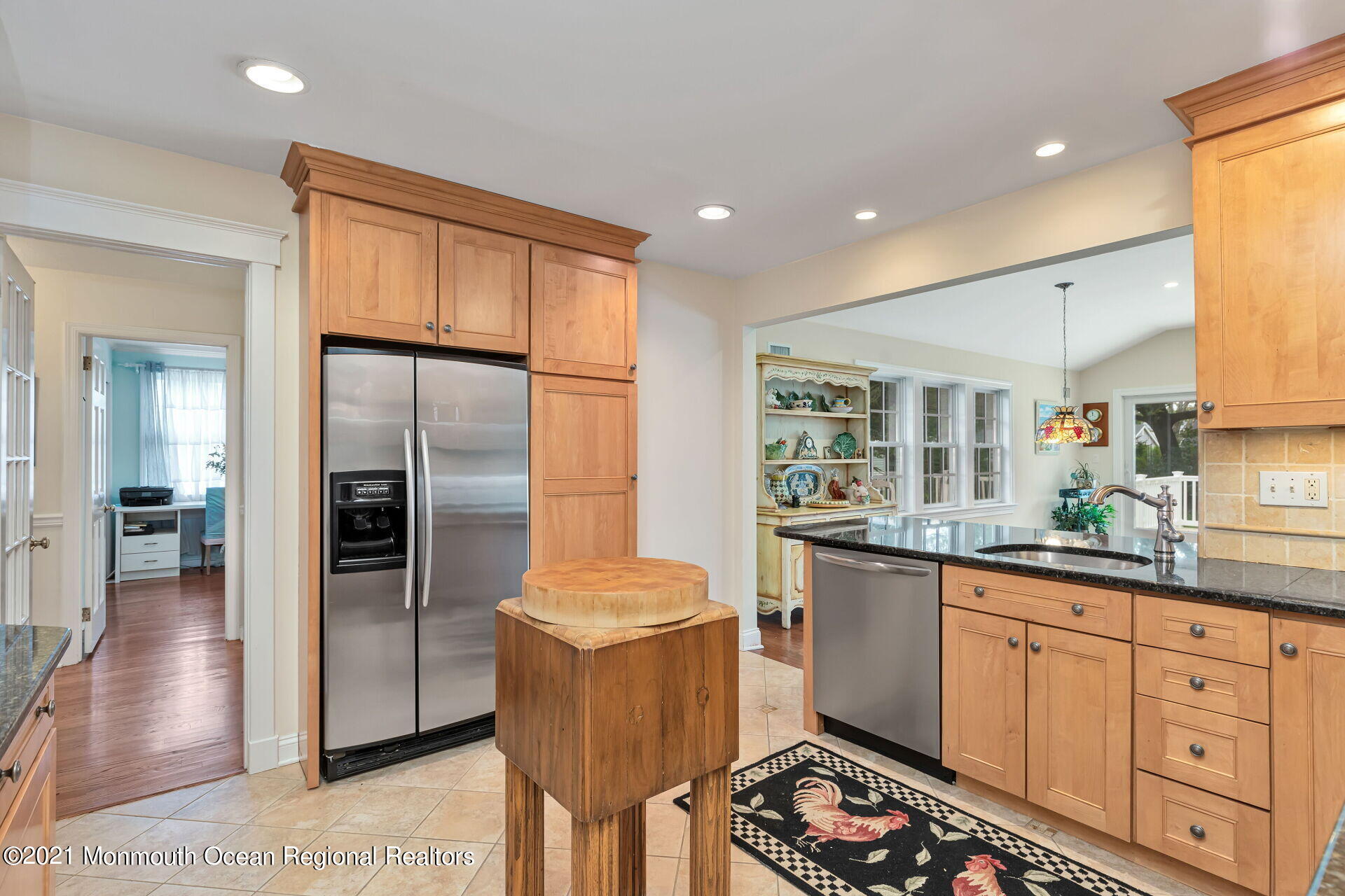 16 Westwood Road Little Silver, NJ 07739 - Photo 22 of 39 a kitchen with granite countertop a refrigerator a sink a stove and white cabinets