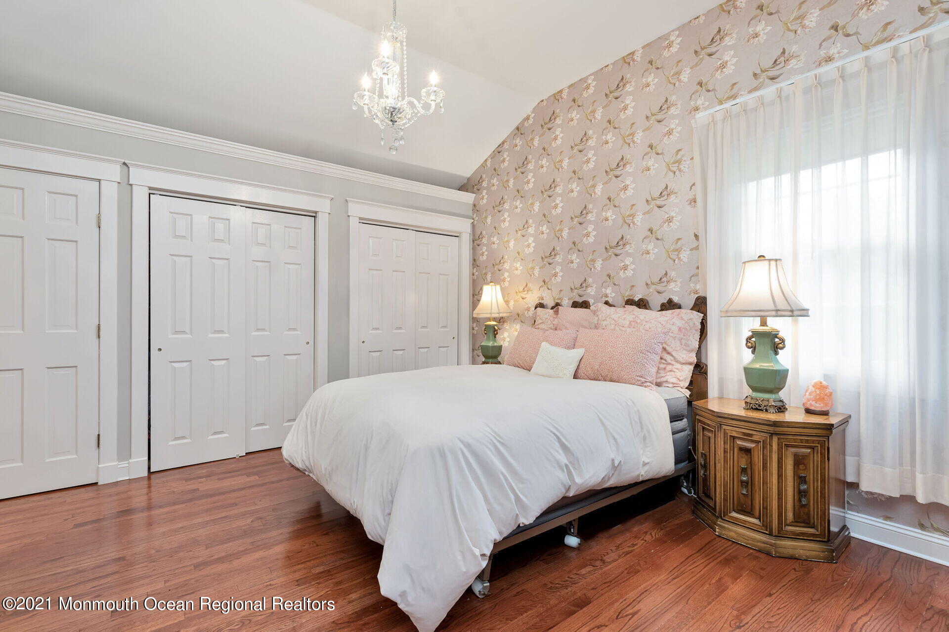 16 Westwood Road Little Silver, NJ 07739 - Photo 24 of 39 a bedroom with a large bed and a chandelier