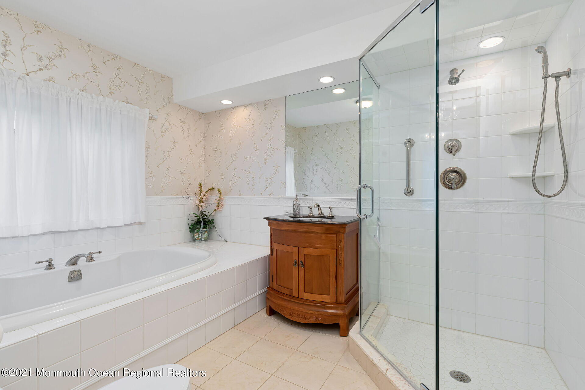 16 Westwood Road Little Silver, NJ 07739 - Photo 25 of 39 a bathroom with a tub a sink and a shower