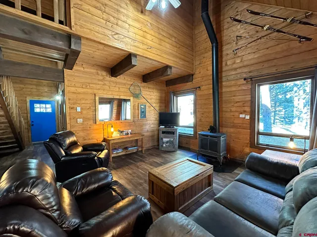 a room with furniture pool table and stainless steel appliances