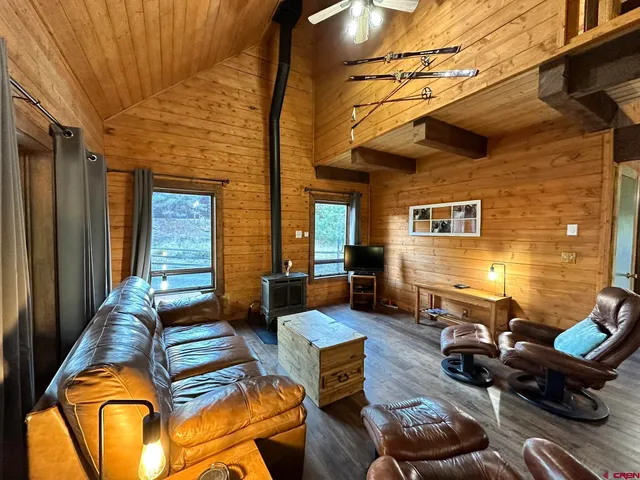 a view of a patio with table and chairs with wooden floor and fence