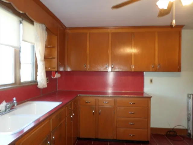 a kitchen with a sink cabinets and a window