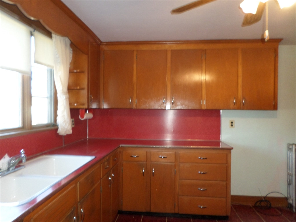 9 Douglas Road Saugus, MA 01906 - Photo 12 of 31 a kitchen with a sink cabinets and a window