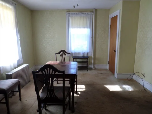 a view of a dining room with furniture and window