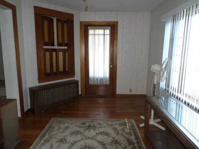 a view of front door with wooden floor