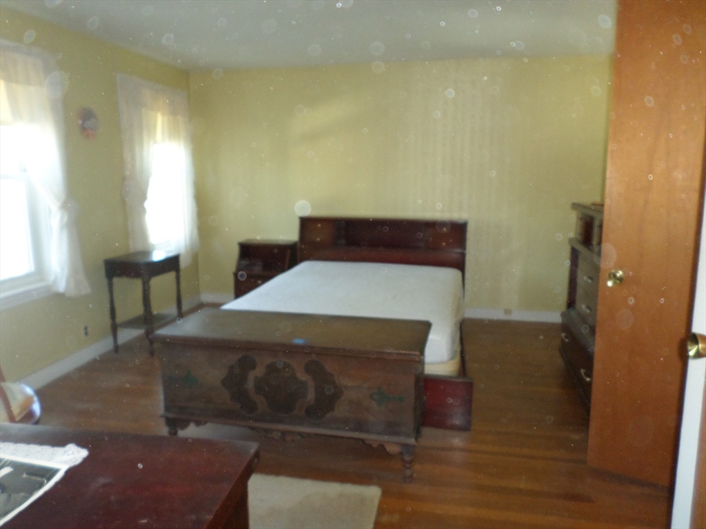 9 Douglas Road Saugus, MA 01906 - Photo 21 of 31 a bed sitting in a bedroom next to a window