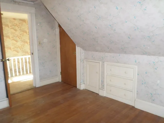 a view of an empty room and a window