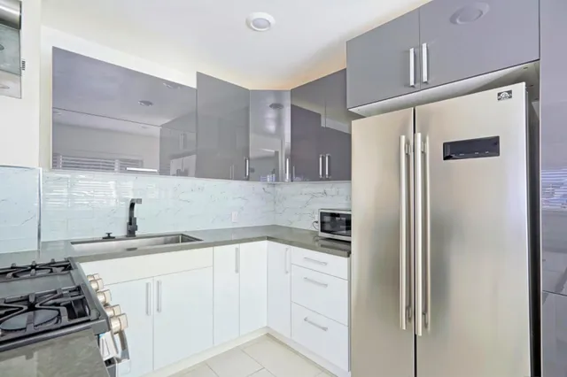 a kitchen with a sink stove and refrigerator