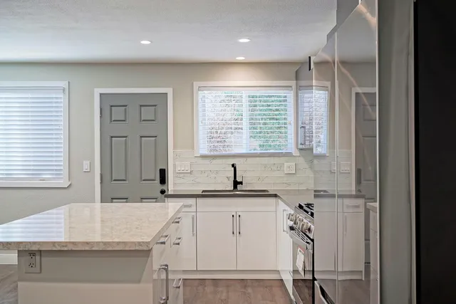 a kitchen with a sink stove and cabinets