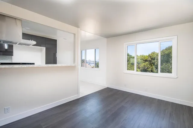 a view of kitchen with furniture and wooden floor