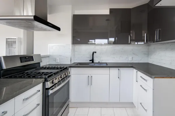 a kitchen with a sink stove and cabinets
