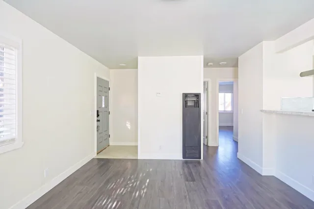 a view of hallway with wooden floor