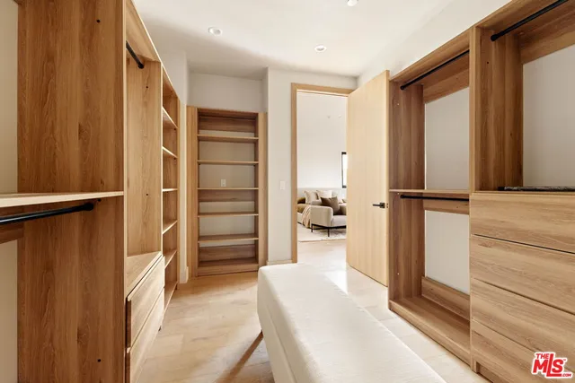 a bathroom with double vanity sinks a mirror and a shower