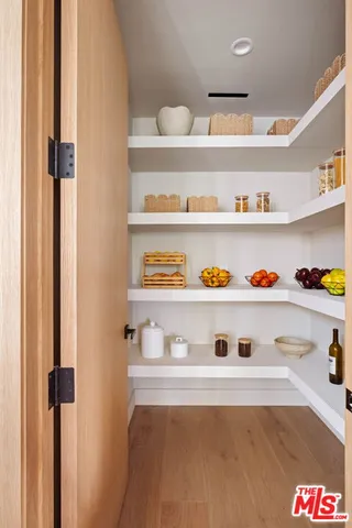 a large white kitchen with living room stove and white cabinets