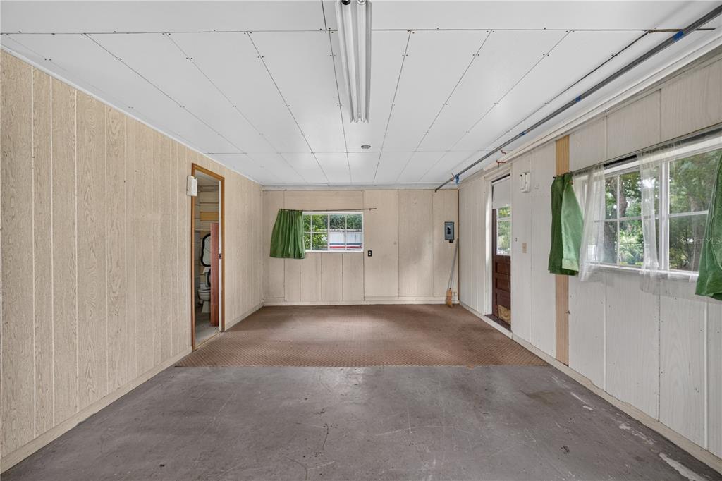 5514 Southeast Hames Road Belleview, FL 34420 - Photo 26 of 44 a view of a big room with wooden floor and windows