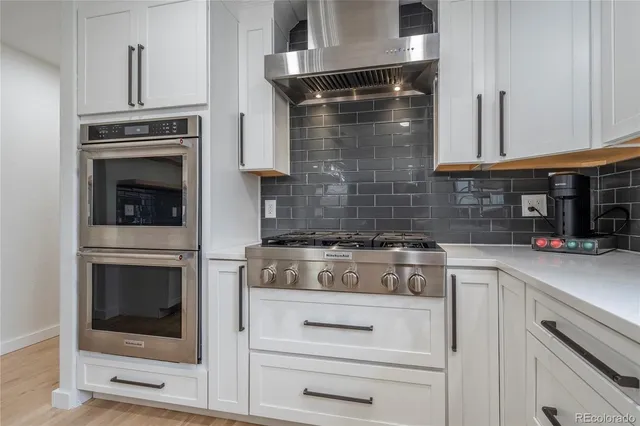 a kitchen with cabinets and appliances