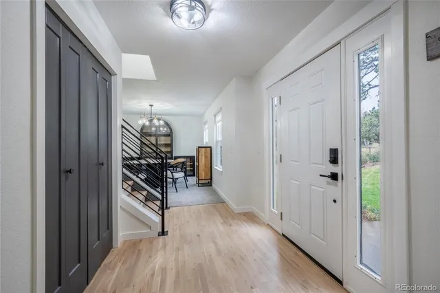 a view of a hallway with wooden floor and stairs