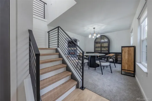 a view of a livingroom with furniture and stairs