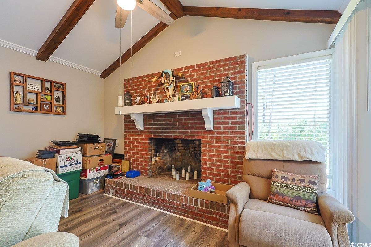 1704 Sherwood Drive Conway, SC 29526 - Photo 12 of 32 Living area with a brick fireplace, wood finished floors, and ceiling fan
