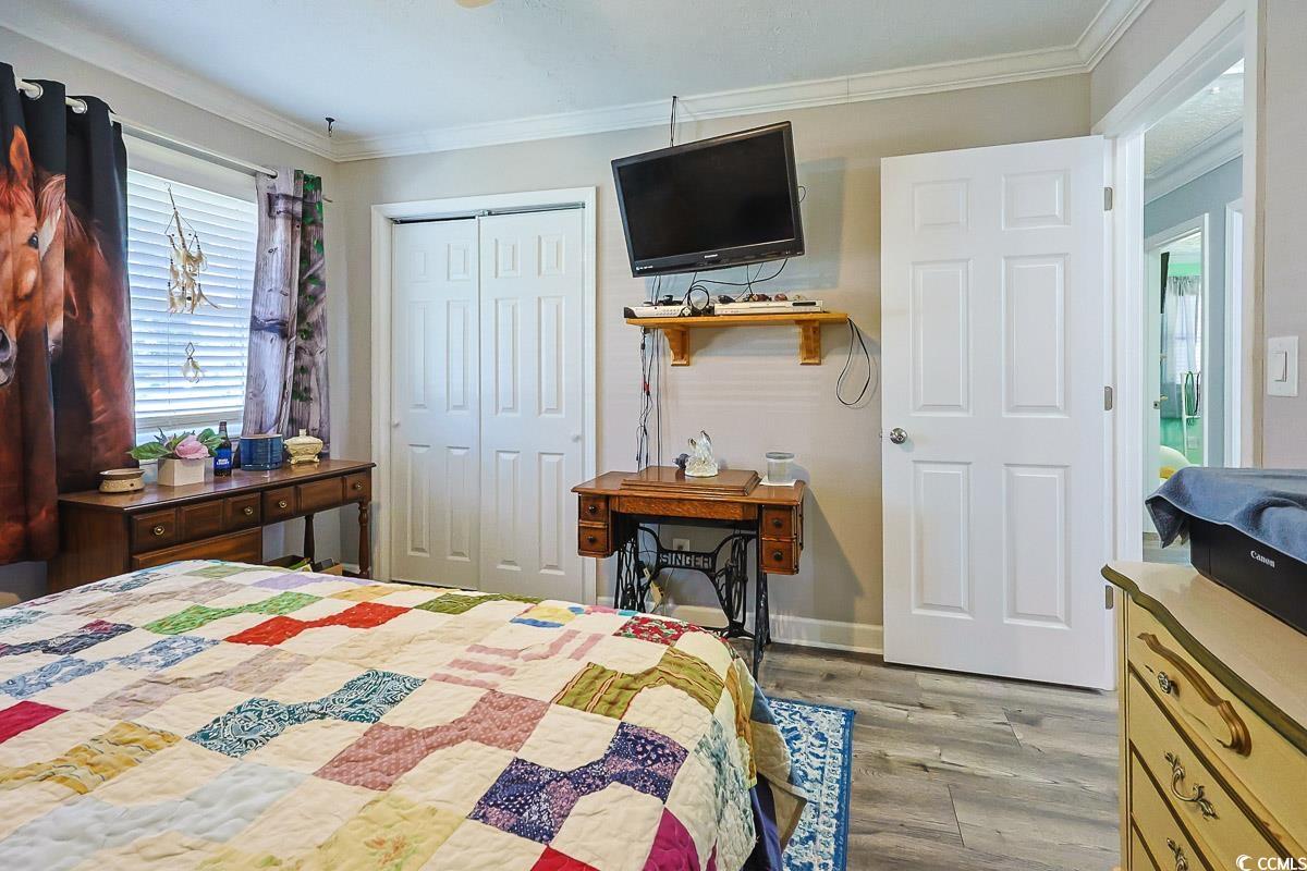 1704 Sherwood Drive Conway, SC 29526 - Photo 23 of 32 Bedroom with crown molding, light wood-style flooring, and a closet