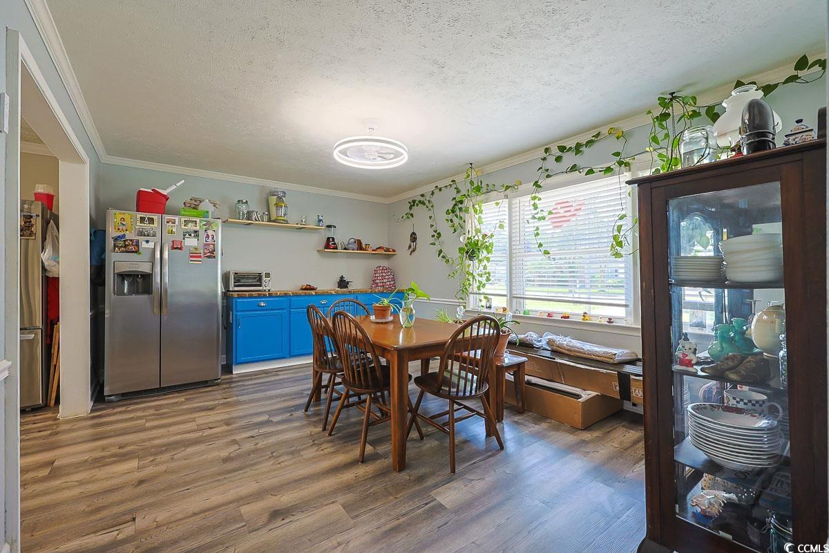1704 Sherwood Drive Conway, SC 29526 - Photo 8 of 32 Dining space featuring wood finished floors, crown molding, and a textured ceiling