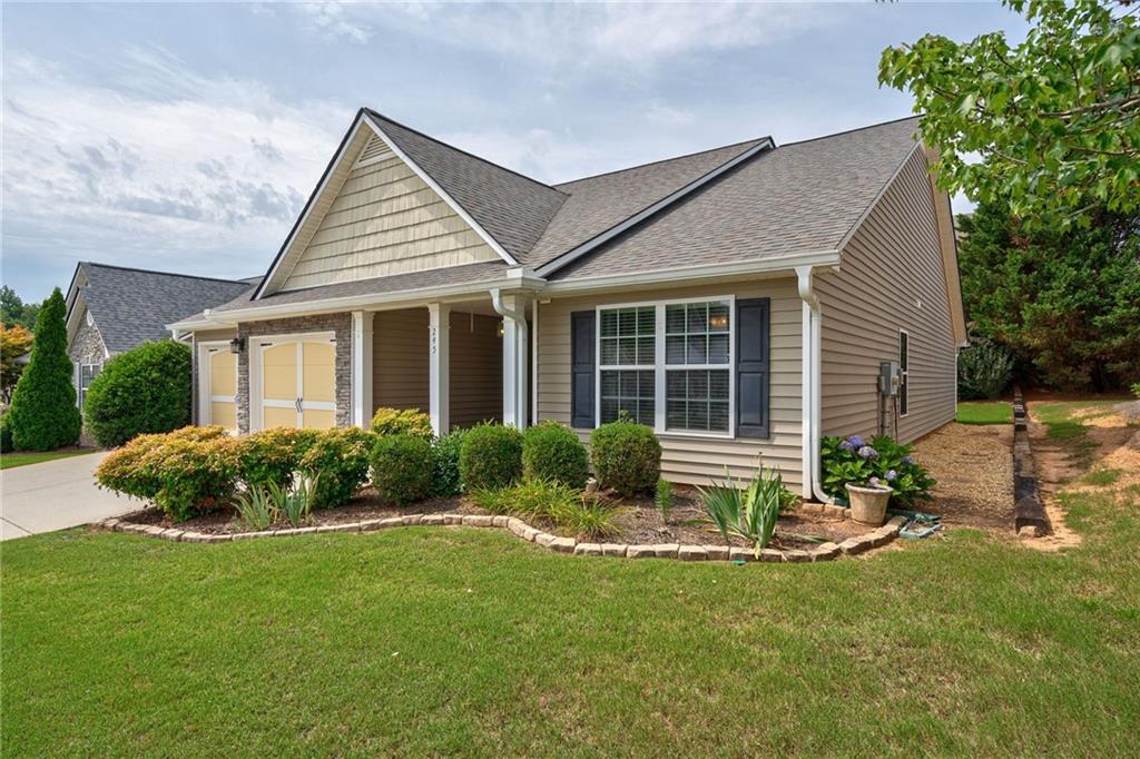 245 Memory Lane Winder, GA 30680 - Photo 2 of 62 a front view of a house with garden and porch