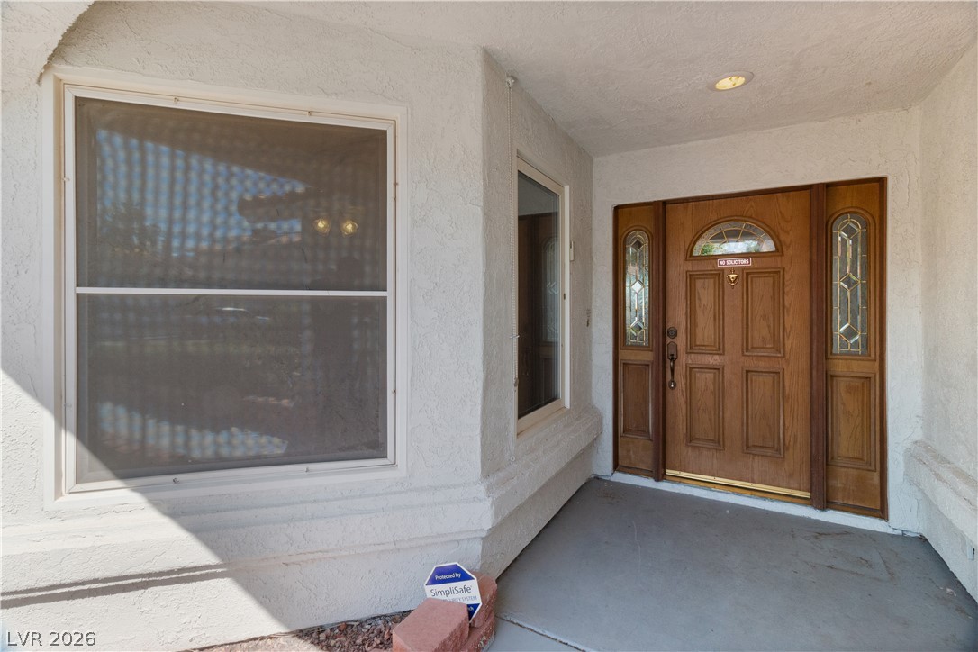 2055 Cholla Way Laughlin, NV 89029 - Photo 5 of 87 A classic wooden entry door with leaded glass sidelights welcomes you home.