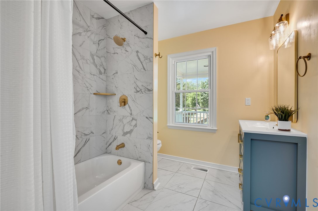 10110 Holly Road Mechanicsville, VA 23116 - Photo 16 of 26 Bathroom featuring a white subway tile shower, gol