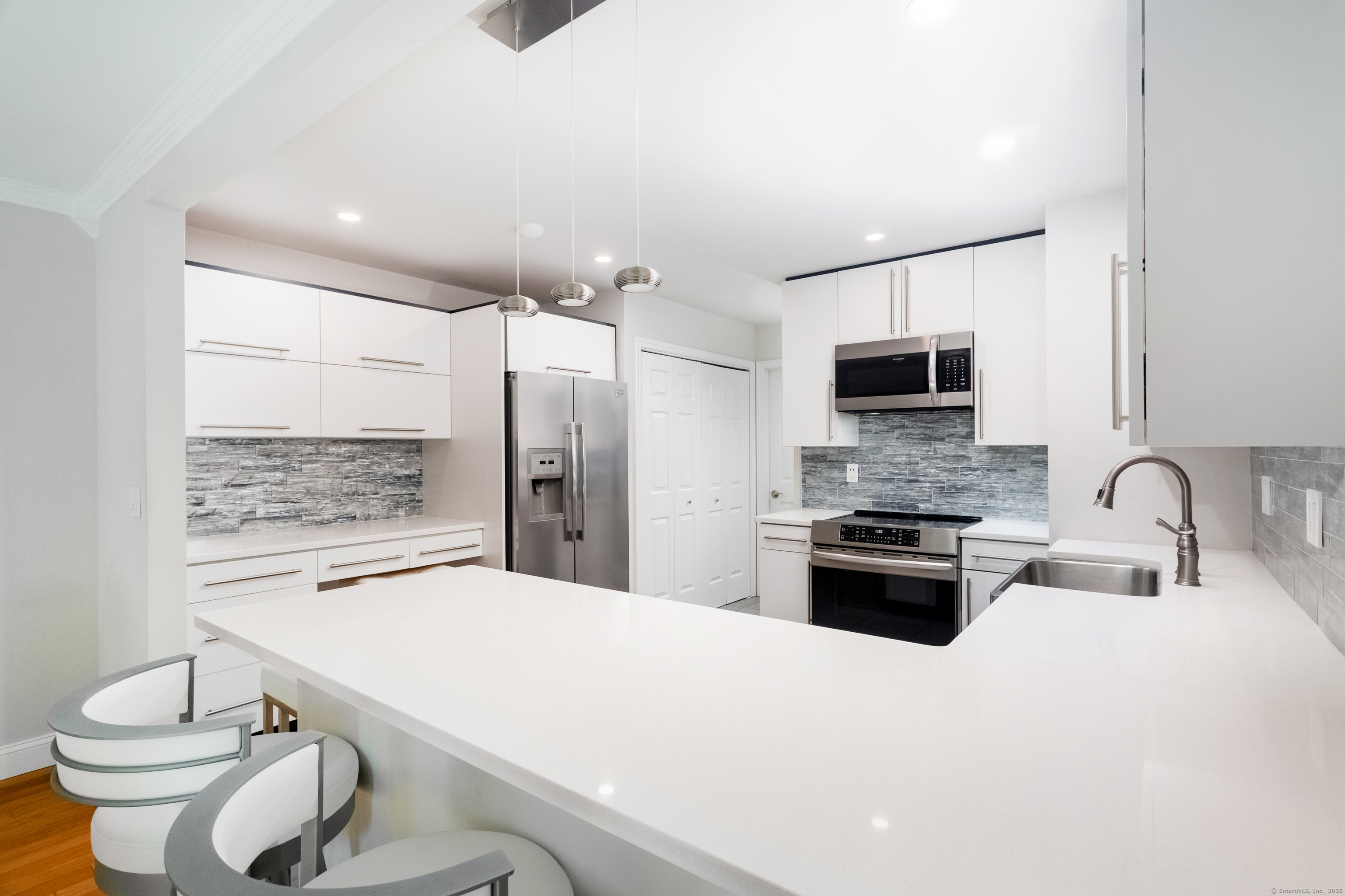 4 Pond View Drive, Unit 4 Brookfield, CT 06804 - Photo 14 of 38 a kitchen with stainless steel appliances a sink stove and refrigerator