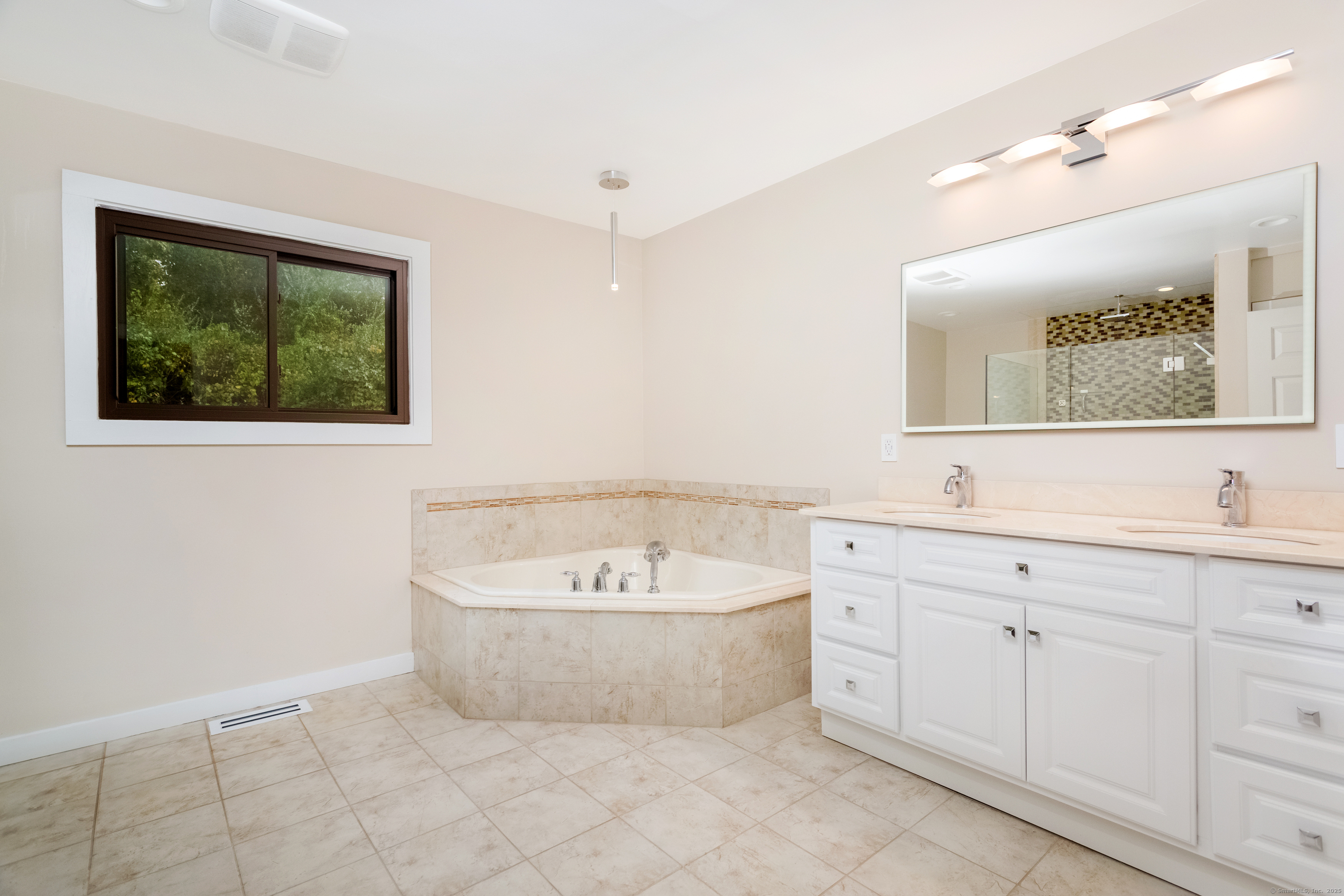 4 Pond View Drive, Unit 4 Brookfield, CT 06804 - Photo 24 of 38 a bathroom with a bathtub sink and mirror