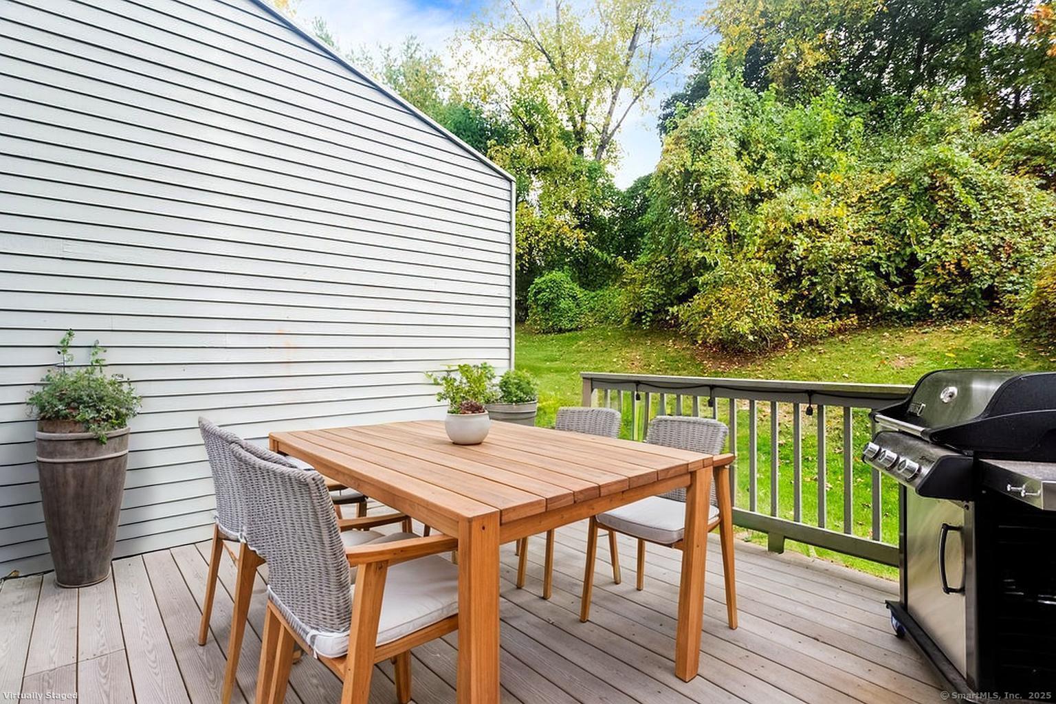 4 Pond View Drive, Unit 4 Brookfield, CT 06804 - Photo 29 of 38 a view of a balcony with table and chairs and wooden floor