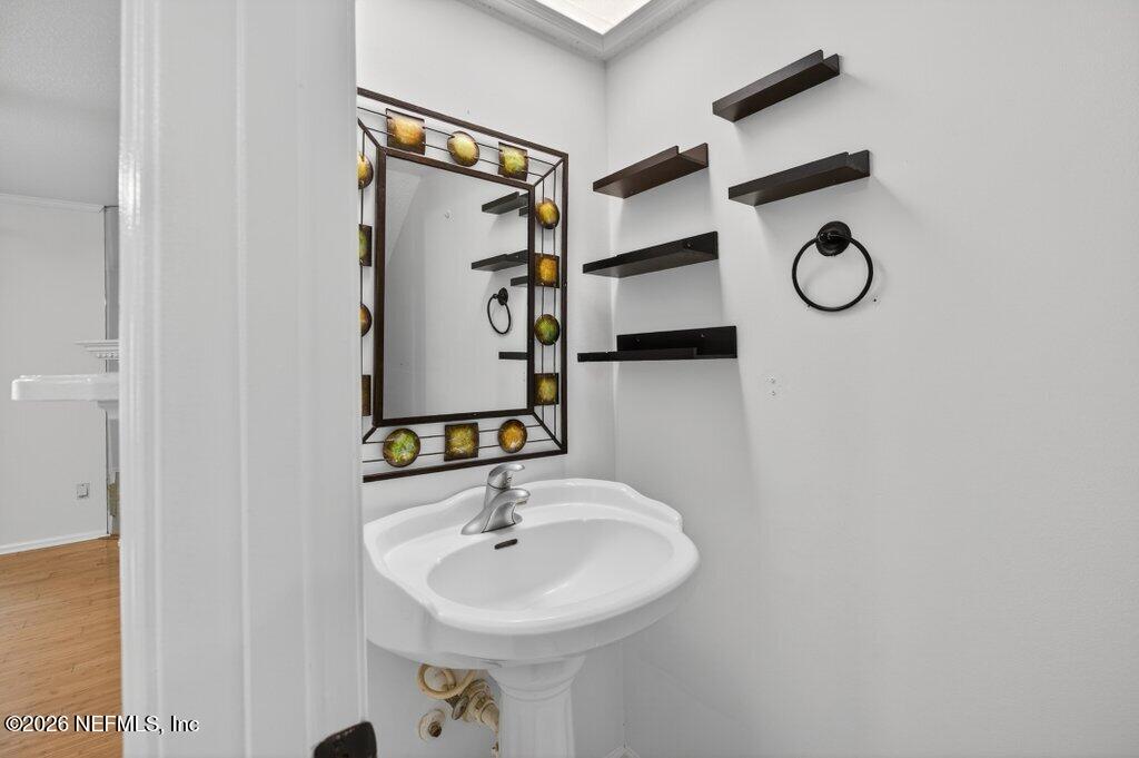 3801 Crown Point Road, Unit 2072 Jacksonville, FL 32257 - Photo 16 of 38 a bathroom with a sink and mirror