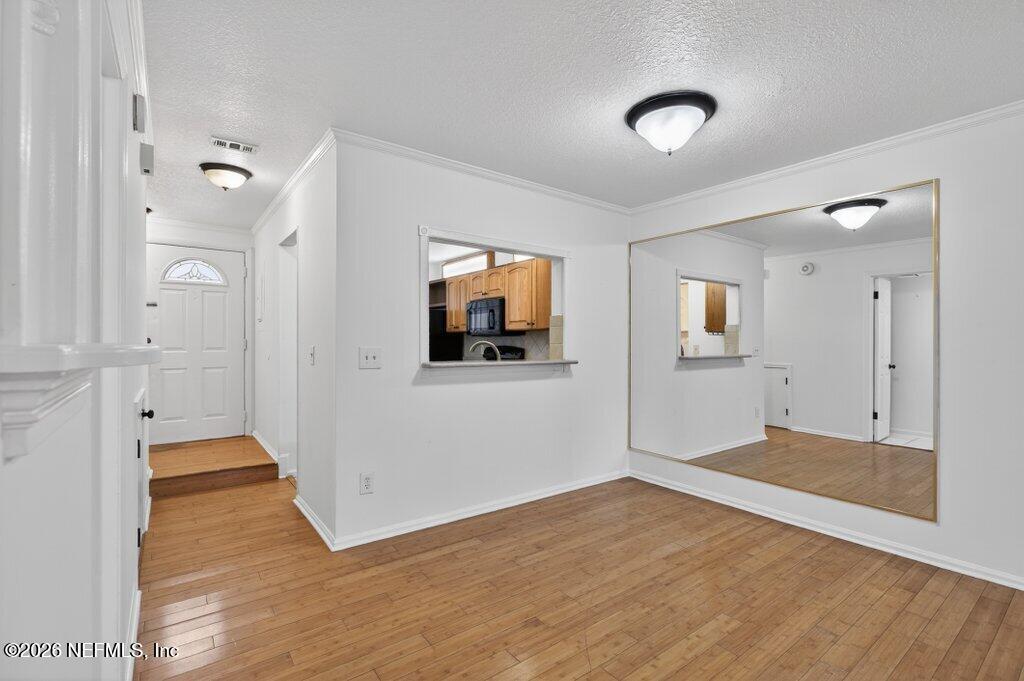 3801 Crown Point Road, Unit 2072 Jacksonville, FL 32257 - Photo 17 of 38 a view of a room with wooden floor and mirror