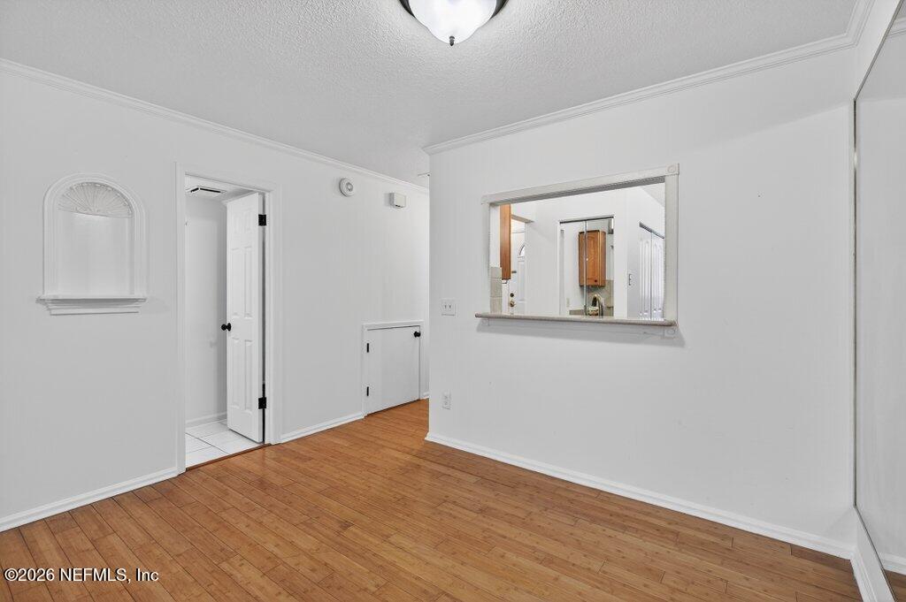 3801 Crown Point Road, Unit 2072 Jacksonville, FL 32257 - Photo 18 of 38 a view of a hallway with wooden floor and closet