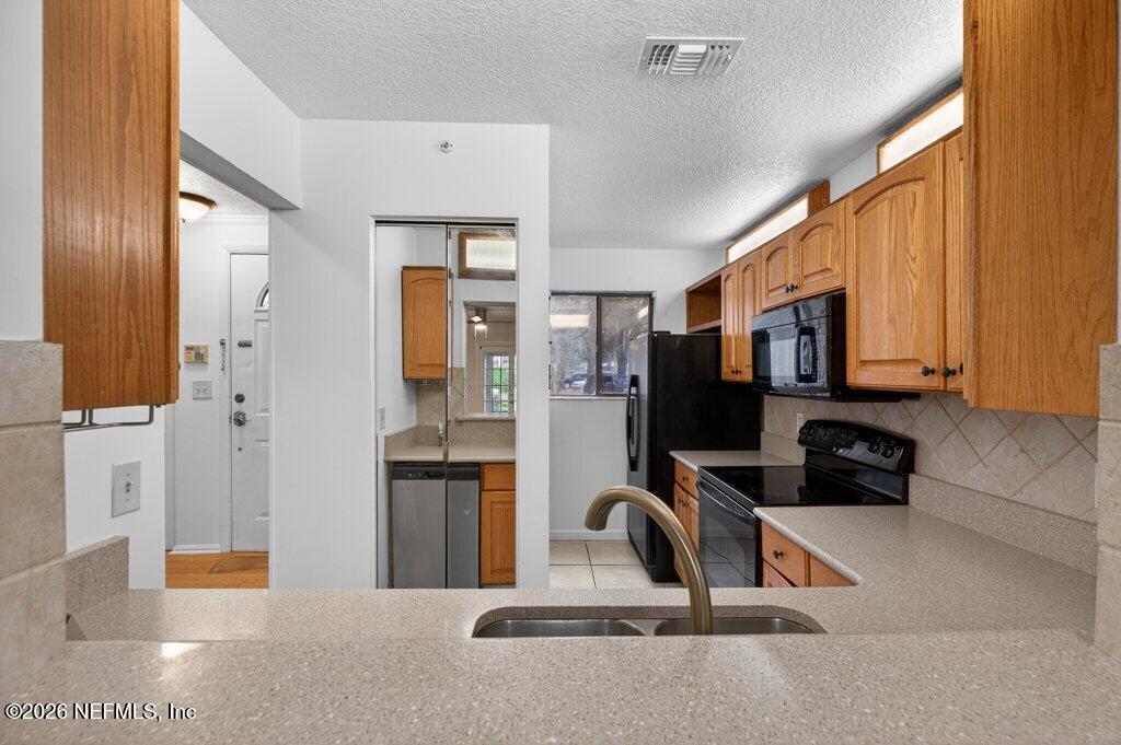 3801 Crown Point Road, Unit 2072 Jacksonville, FL 32257 - Photo 19 of 38 a kitchen with stainless steel appliances a refrigerator and cabinets