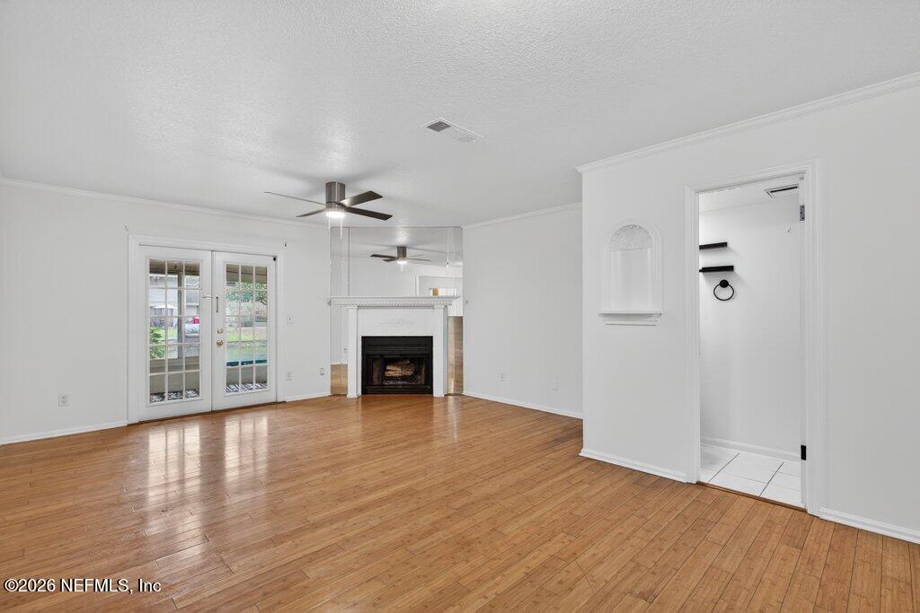 3801 Crown Point Road, Unit 2072 Jacksonville, FL 32257 - Photo 20 of 38 a view of an empty room with wooden floor fireplace and a window