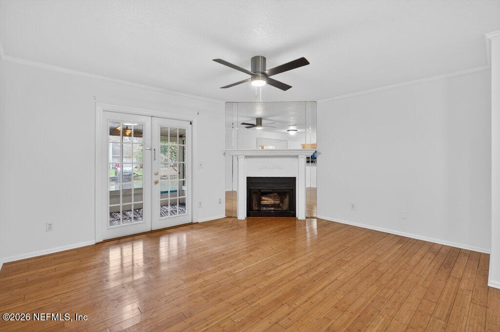3801 Crown Point Road, Unit 2072 Jacksonville, FL 32257 - Photo 21 of 38 a view of an empty room with wooden floor a ceiling fan and a window